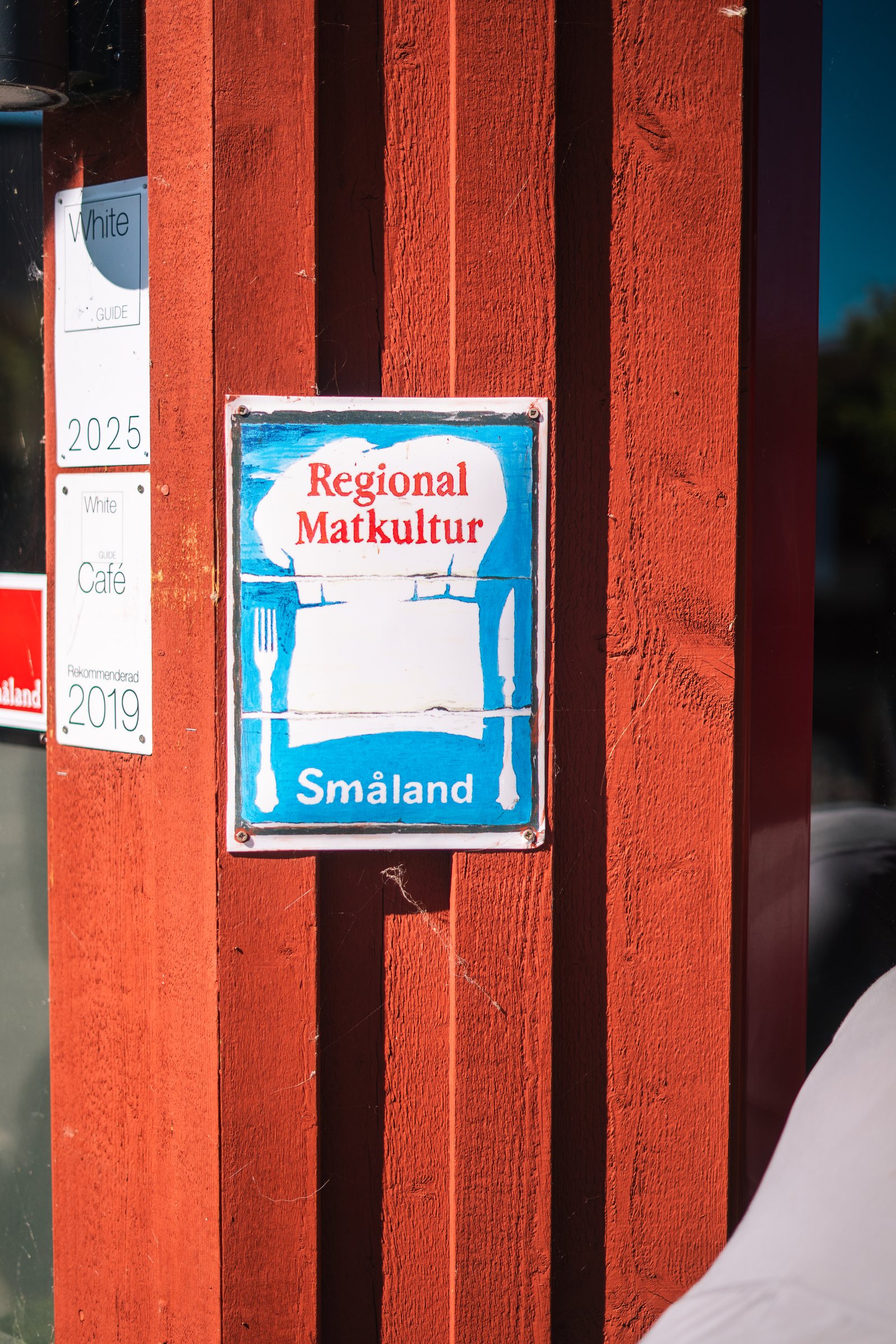 Regional Matkultur Småland sign on a red wooden wall at Rudenstams