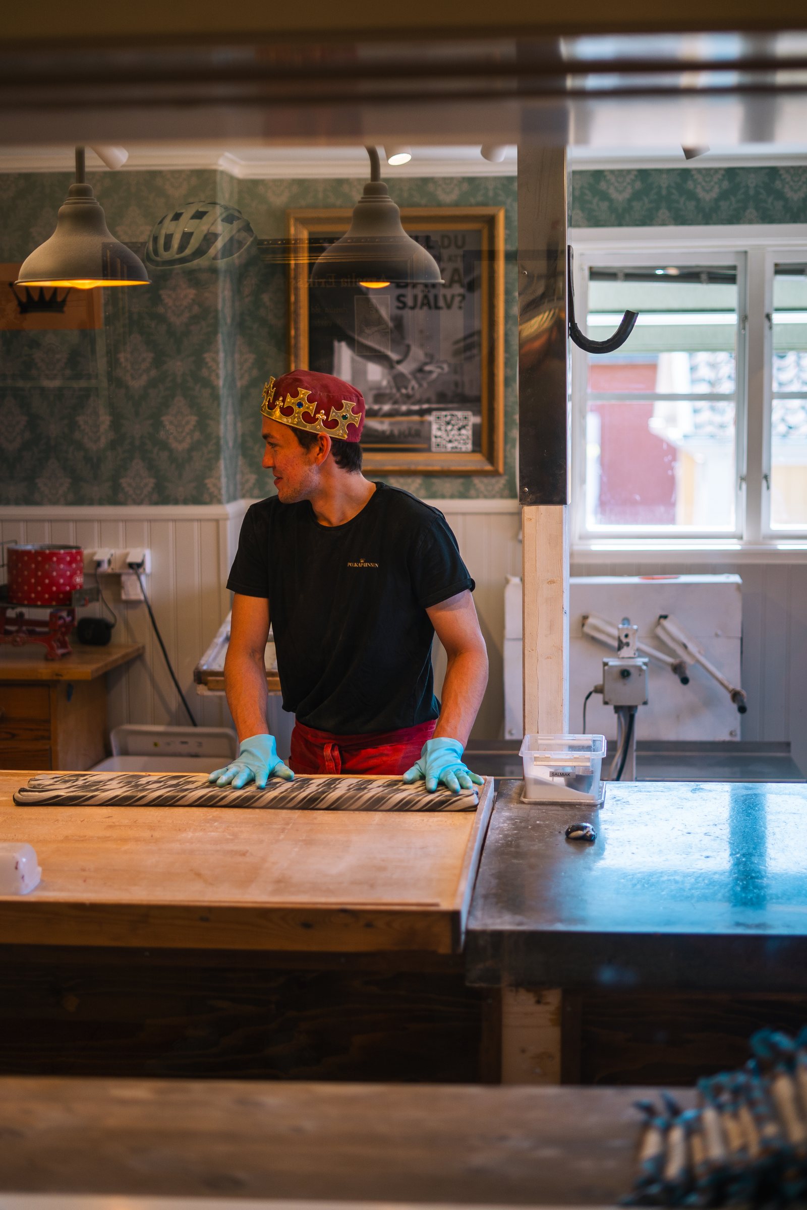 Candy maker working a batch of polkagris at the counter in Gränna