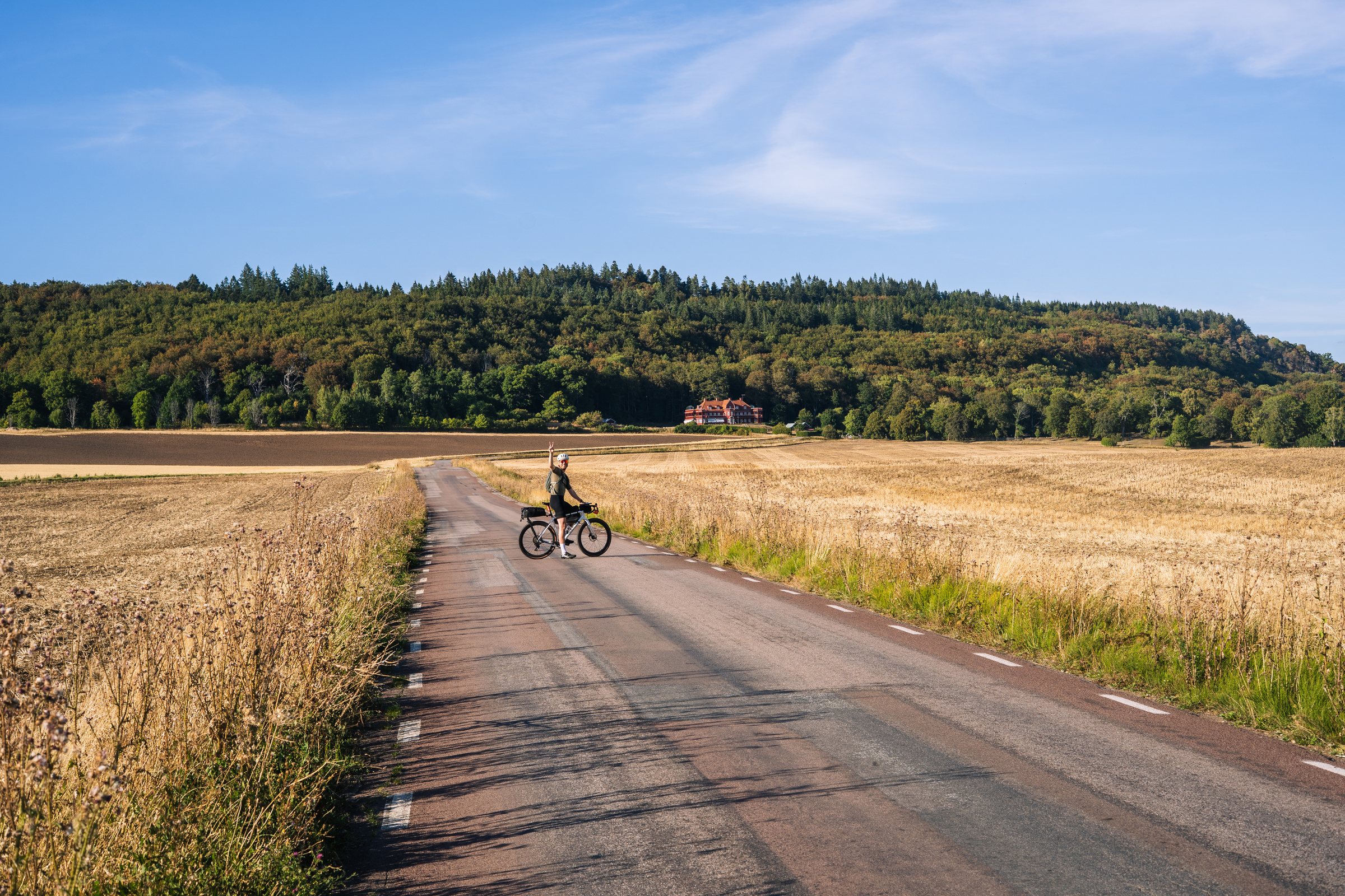 Ombergs Turisthotell at the foot of Omberg, seen across golden fields