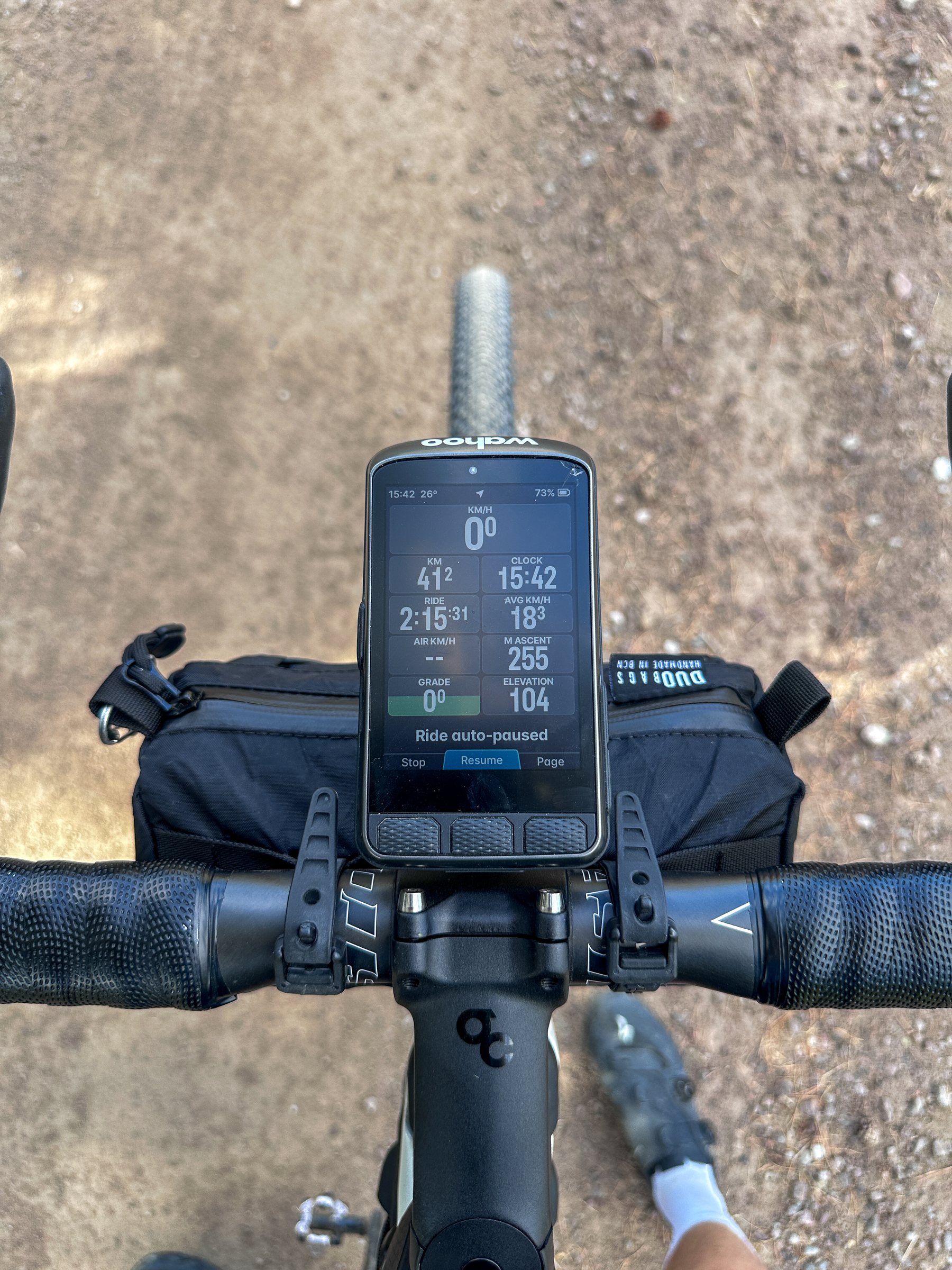 Bike computer and handlebar bag seen from the saddle on a gravel road